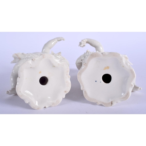 72 - A PAIR OF EARLY 20TH CENTURY WHITE GLAZED PORCELAIN FIGURES modelled upon a shaped base. 16 cm high.