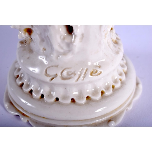 72 - A PAIR OF EARLY 20TH CENTURY WHITE GLAZED PORCELAIN FIGURES modelled upon a shaped base. 16 cm high.