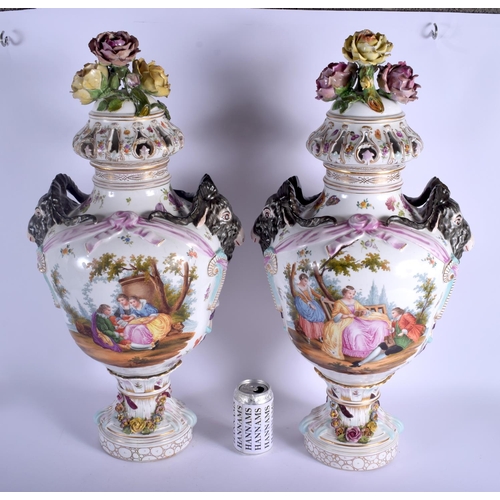74 - A LARGE PAIR OF EARLY 20TH CENTURY GERMAN PORCELAIN VASES AND COVERS Meissen style, painted with lov... 