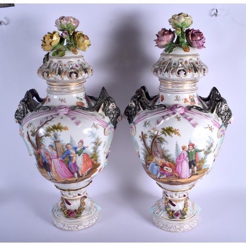 74 - A LARGE PAIR OF EARLY 20TH CENTURY GERMAN PORCELAIN VASES AND COVERS Meissen style, painted with lov... 