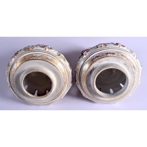 74 - A LARGE PAIR OF EARLY 20TH CENTURY GERMAN PORCELAIN VASES AND COVERS Meissen style, painted with lov... 