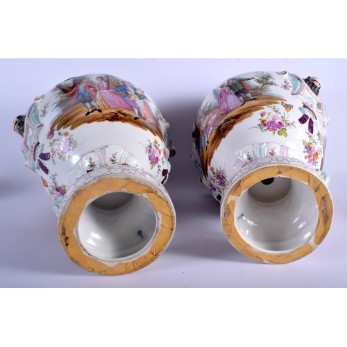 74 - A LARGE PAIR OF EARLY 20TH CENTURY GERMAN PORCELAIN VASES AND COVERS Meissen style, painted with lov... 