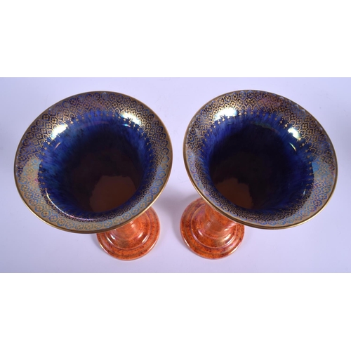 84 - A STYLISH PAIR OF WEDGWOOD LUSTRE ORANGE PORCELAIN VASES with internal foliate border. 25 cm high.