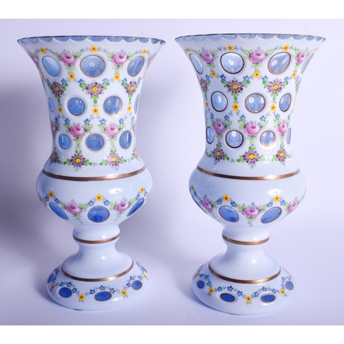 10 - A LARGE PAIR OF BOHEMIAN ENAMELLED GLASS VASES painted with flowers and vines. 24 cm high.