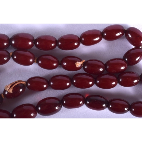 1000 - A 1920S EASTERN RED AMBER NECKLACE. 20 grams. 36 cm long.