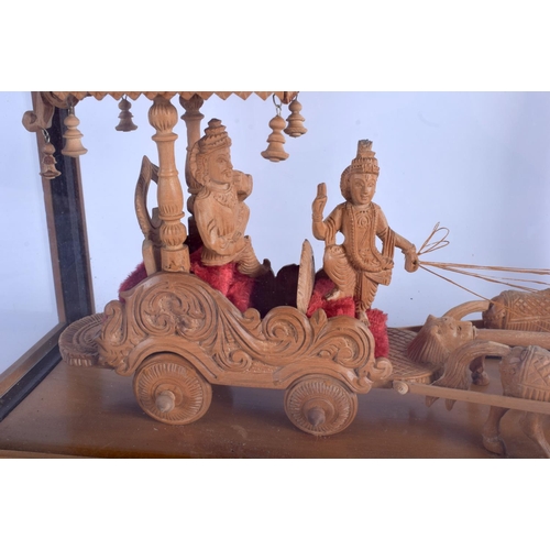 1023 - A 1950S SOUTH EAST ASIAN CARVED SANDALWOOD FIGURE OF A CART modelled with attendants. Figure 37 cm x... 