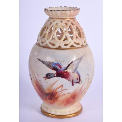 103 - A ROYAL WORCESTER OPENWORK PORCELAIN VASE painted with birds. 11 cm high.