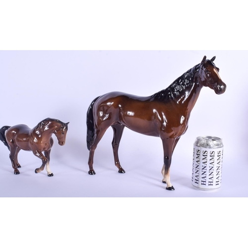 104 - A RARE LARGE BESWICK PORCELAIN HORSE together with a smaller horse. Largest 33 cm x 30 cm. (2)