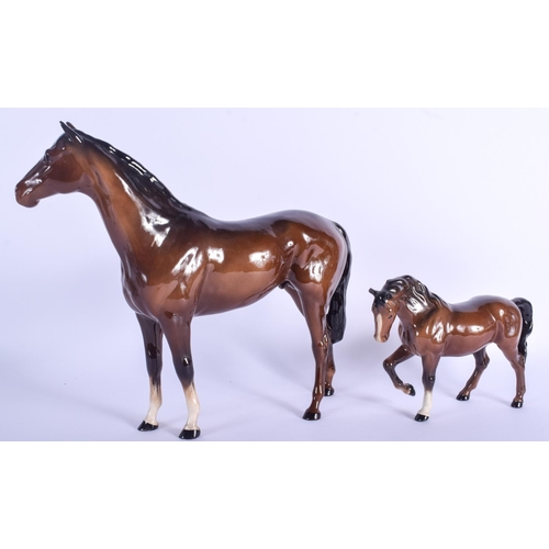 104 - A RARE LARGE BESWICK PORCELAIN HORSE together with a smaller horse. Largest 33 cm x 30 cm. (2)