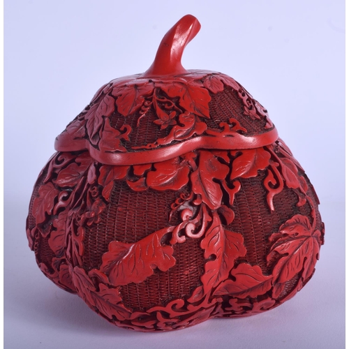 1041 - A 1930S CHINESE RED LACQUER MELON FORM BOX AND COVER decorated with foliage. 12 cm x 12 cm.