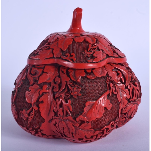 1041 - A 1930S CHINESE RED LACQUER MELON FORM BOX AND COVER decorated with foliage. 12 cm x 12 cm.