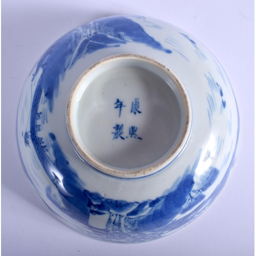 1042 - A 19TH CENTURY CHINESE BLUE AND WHITE PORCELAIN BOWL bearing Kangxi marks to base, painted with land... 