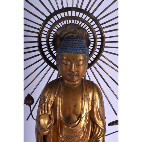 1052 - A VERY LARGE 18TH/19TH CENTURY JAPANESE EDO PERIOD GILT WOOD BUDDHA modelled with a metal sunburst u... 