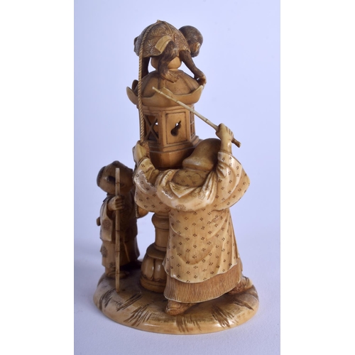 1062 - A 19TH CENTURY JAPANESE MEIJI PERIOD CARVED IVORY OKIMONO modelled as two figures beside a hound & a... 