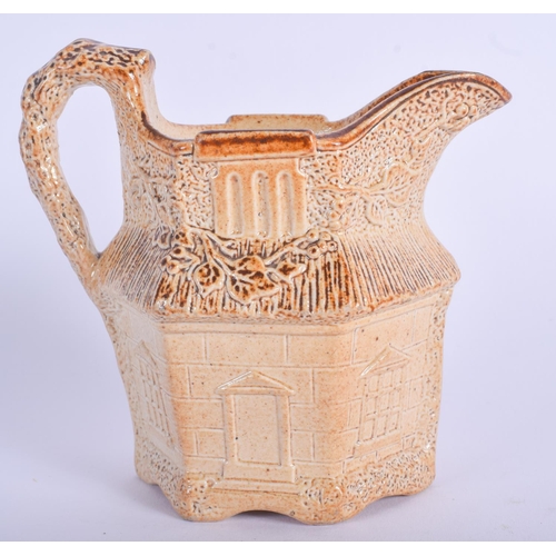 107 - A VERY RARE 19TH CENTURY ENGLISH STONEWARE CREAM JUG in the form of a house. 11 cm x 8 cm.