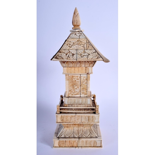 1101 - A 19TH CENTURY JAPANESE MEIJI PERIOD CARVED IVORY PAGODA inset with a seated buddha. 30 cm x 8 cm.