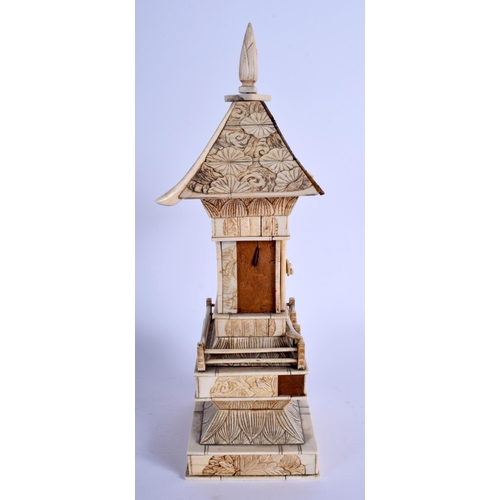 1101 - A 19TH CENTURY JAPANESE MEIJI PERIOD CARVED IVORY PAGODA inset with a seated buddha. 30 cm x 8 cm.