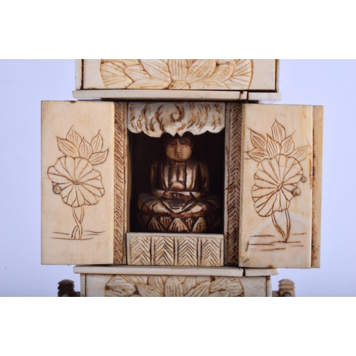 1101 - A 19TH CENTURY JAPANESE MEIJI PERIOD CARVED IVORY PAGODA inset with a seated buddha. 30 cm x 8 cm.