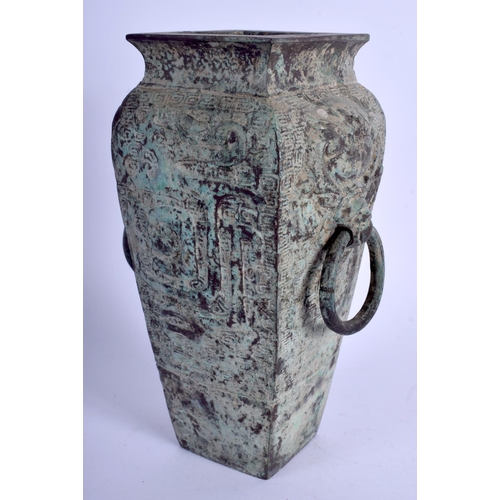 1106 - A 1930S CHINESE BRONZE SQUARE FORM VASE of archaic form, decorated with mask heads. 23 cm x 9 cm.