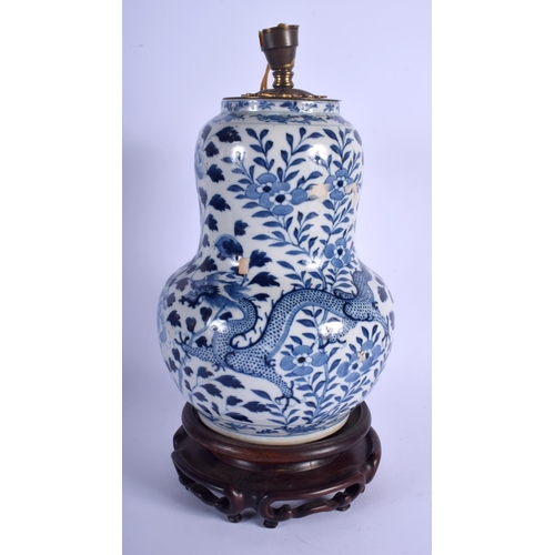 1114 - A 19TH CENTURY CHINESE BLUE AND WHITE BULBOUS DRAGON VASE converted to a lamp, painted with foliage ... 