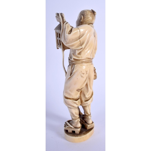 1125 - A 19TH CENTURY JAPANESE MEIJI PERIOD CARVED IVORY OKIMONO modelled as a male holding a lantern. 20 c... 