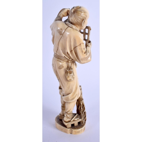 1125 - A 19TH CENTURY JAPANESE MEIJI PERIOD CARVED IVORY OKIMONO modelled as a male holding a lantern. 20 c... 