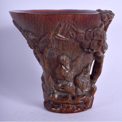 1130 - A CHINESE CARVED BUFFALO HORN TYPE LIBATION CUP decorated with figures within landscapes. 719 grams.... 