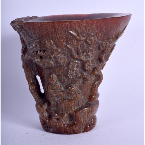 1130 - A CHINESE CARVED BUFFALO HORN TYPE LIBATION CUP decorated with figures within landscapes. 719 grams.... 