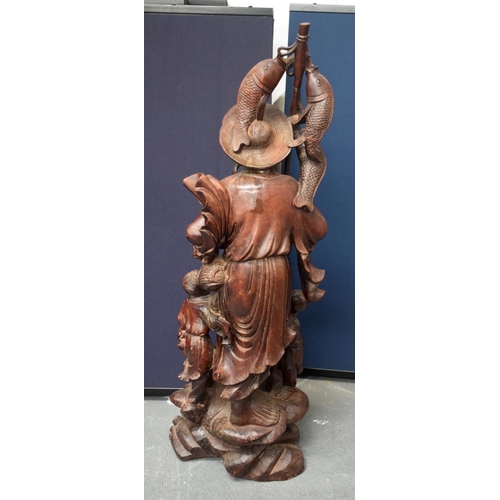 1148 - A VERY LARGE 19TH CENTURY CHINESE HARDWOOD FIGURE OF A FISHERMAN Qing, of monumental proportions. 86... 