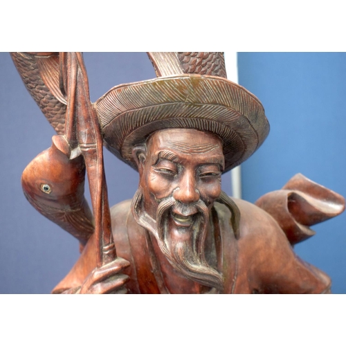 1148 - A VERY LARGE 19TH CENTURY CHINESE HARDWOOD FIGURE OF A FISHERMAN Qing, of monumental proportions. 86... 