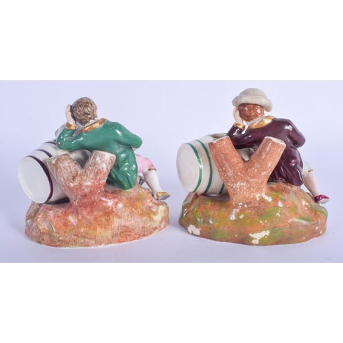 117 - A RARE PAIR OF 19TH CENTURY ENGLISH PORCELAIN FIGURES modelled as two drunken males upon barrels. 8 ... 