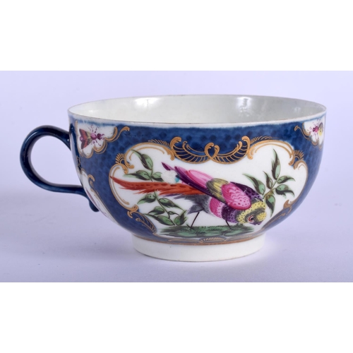 121 - 18th c. Worcester teacup and saucer painted with birds in a gilt mirror shaped panel on a blue scale... 