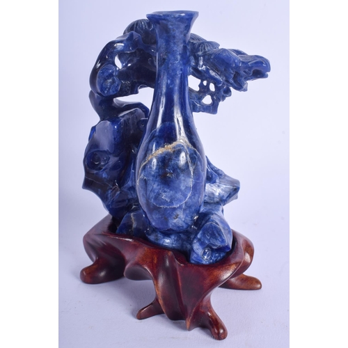 1227 - AN EARLY 20TH CENTURY CHINESE CARVED LAPIS LAZULI FIGURE Late Qing/Republic, of flowering form. Lapi... 