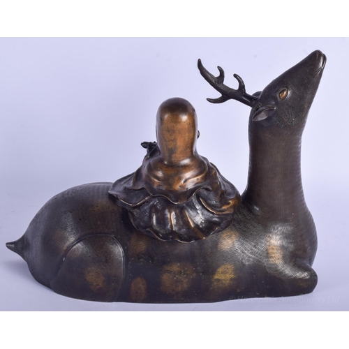 1230 - A LARGE 18TH/19TH CENTURY CHINESE BRONZE FIGURE OF A DEER Qing, modelled with a seated scholar upon ... 