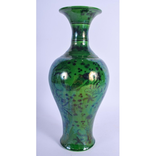 1238 - A CHINESE GREEN GLAZED PORCELAIN FISH VASE 20th Century, decorated with reeds and lotus. 30 cm high.