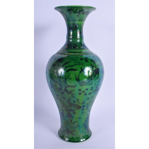 1238 - A CHINESE GREEN GLAZED PORCELAIN FISH VASE 20th Century, decorated with reeds and lotus. 30 cm high.