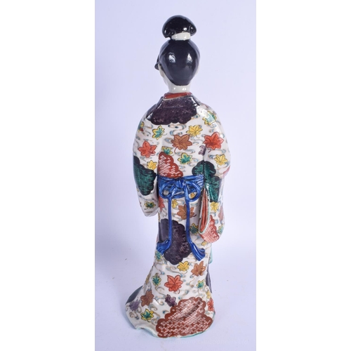 1255 - A 19TH CENTURY JAPANESE MEIJI PERIOD KAKIEMON IMARI FIGURE OF A FEMALE modelled holding a fan. 32 cm... 