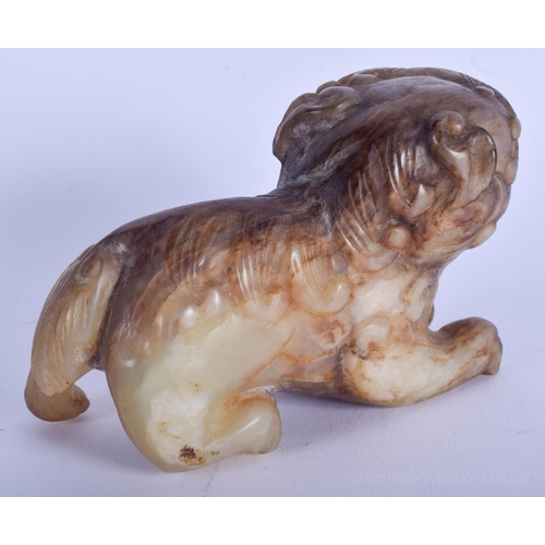 1257 - A CHINESE QING DYNASTY CARVED MUTTON JADE BUDDHISTIC LION modelled roaming and scowling. 9 cm x 6 cm... 