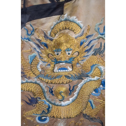 1262 - A VERY LARGE 19TH CENTURY FRAMED IMPERIAL CHINESE ROBE Qing, decorated with dragons amongst crashing... 