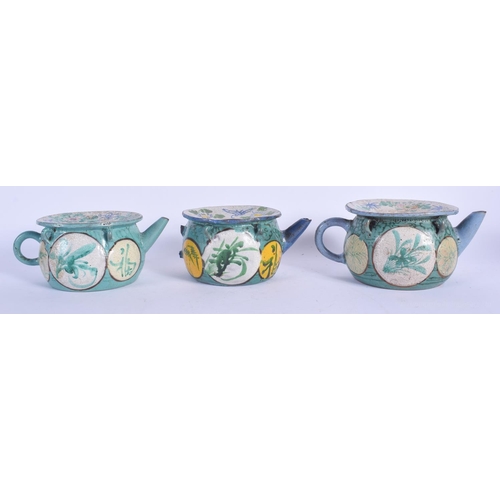 1265 - THREE EARLY 20TH CENTURY CHINESE YIXING POTTERY TEAPOTS Late Qing/Republic, enamelled with flowers. ... 