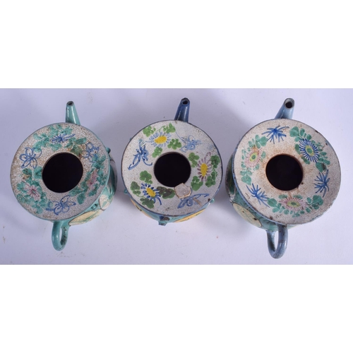 1265 - THREE EARLY 20TH CENTURY CHINESE YIXING POTTERY TEAPOTS Late Qing/Republic, enamelled with flowers. ... 