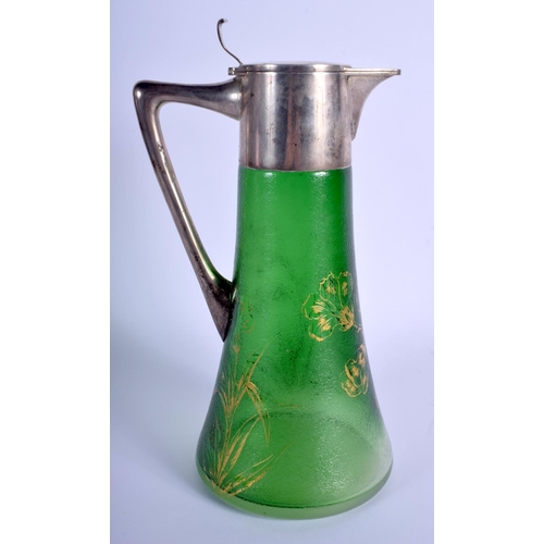 13 - A LARGE ART NOUVEAU SILVER MOUNTED GREEN GLASS CLARET JUG painted with gilt flowers. 28 cm high.