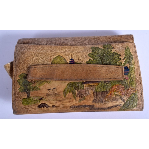 1300 - A 1930S JAPANESE TAISHO PERIOD EMBOSSED LEATHER PURSE decorated with landscapes. 21 cm x 13 cm.