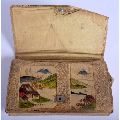 1300 - A 1930S JAPANESE TAISHO PERIOD EMBOSSED LEATHER PURSE decorated with landscapes. 21 cm x 13 cm.