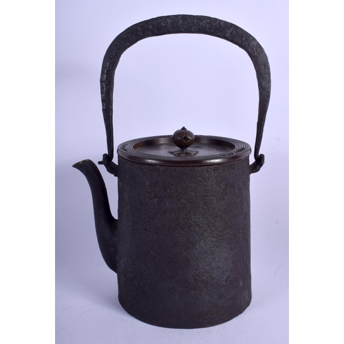 1301 - A 19TH CENTURY CAST IRON AND BRONZE TETSUBIN TEAPOT with peach finial. 25 cm high inc handle.