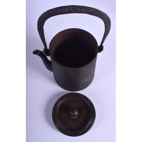 1301 - A 19TH CENTURY CAST IRON AND BRONZE TETSUBIN TEAPOT with peach finial. 25 cm high inc handle.