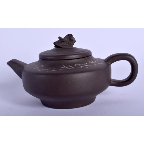 1320 - A CHINESE YIXING POTTERY TEAPOT AND COVER 20th Century, decorated with calligraphy. 11.5 cm wide.