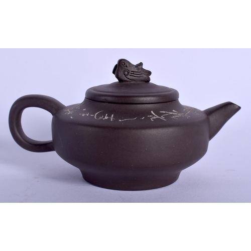 1320 - A CHINESE YIXING POTTERY TEAPOT AND COVER 20th Century, decorated with calligraphy. 11.5 cm wide.