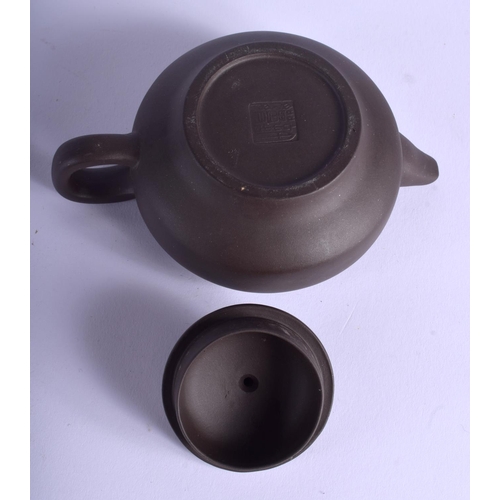 1320 - A CHINESE YIXING POTTERY TEAPOT AND COVER 20th Century, decorated with calligraphy. 11.5 cm wide.