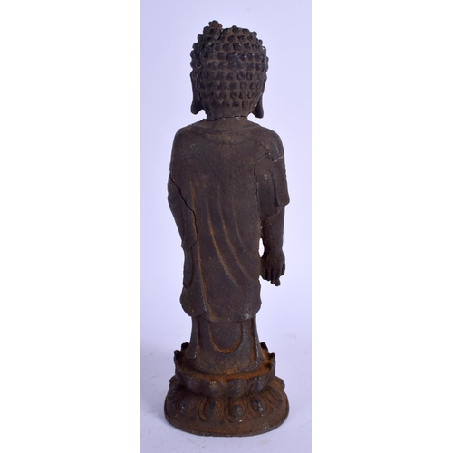 1361 - A CHINESE MING DYNASTY IRON FIGURE OF A STANDING BUDDHA modelled upon a lotus capped base. 29 cm hig... 